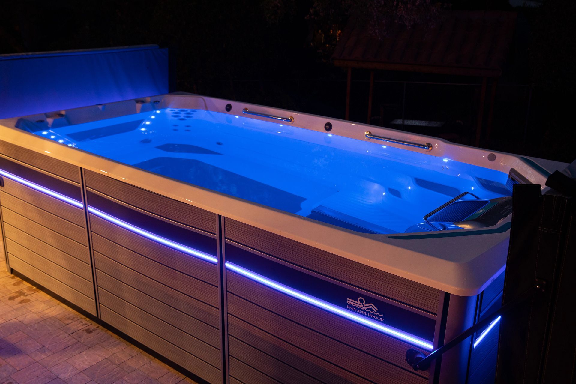Endless Pools swim spa in a backyard at night